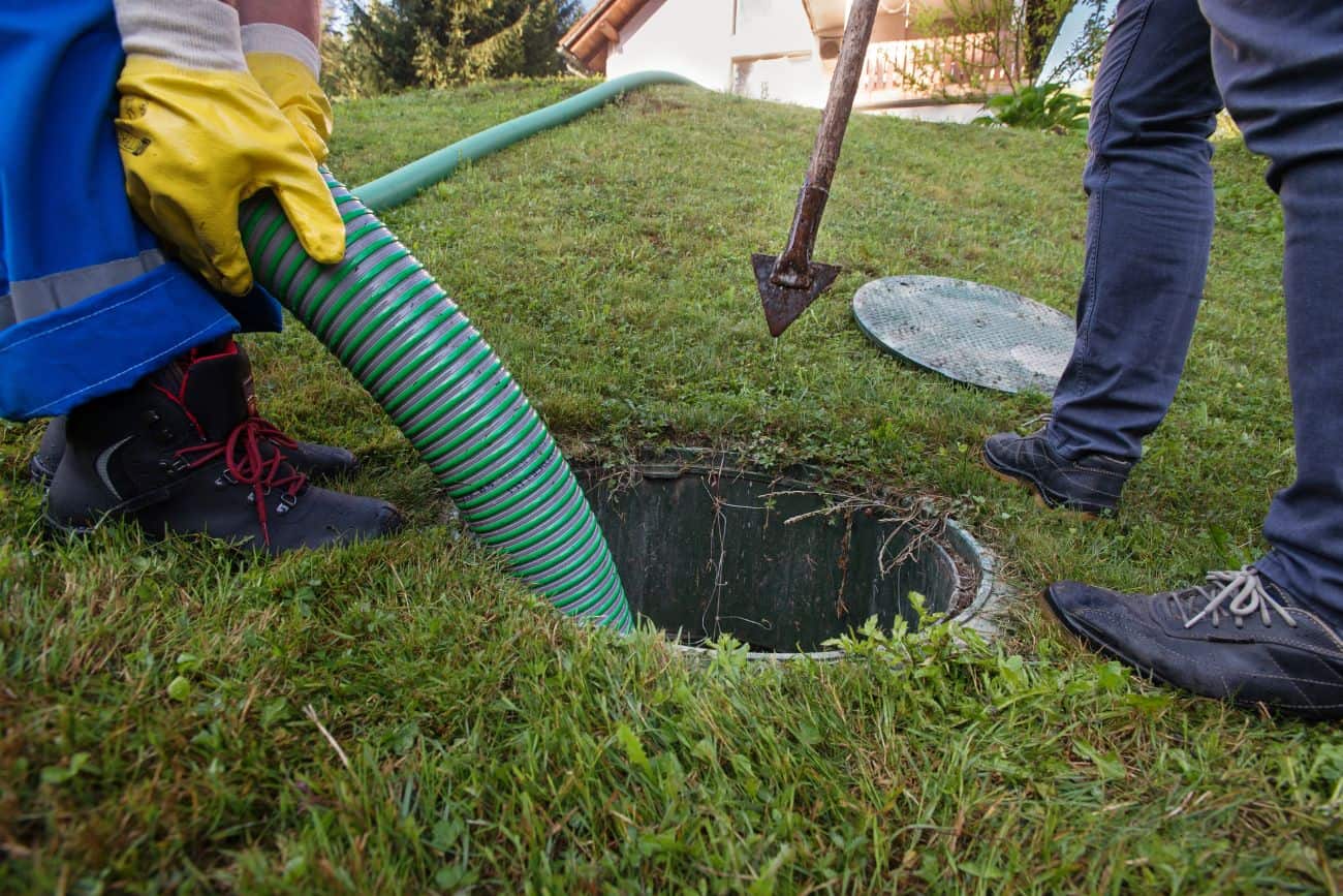 Drain cleaning being down outside a house