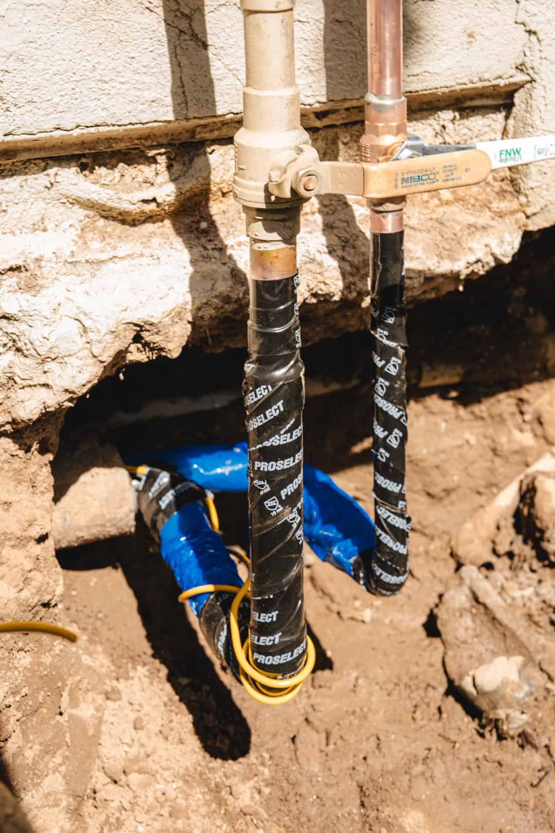 Taped up copper pipes for an outdoor fixture
