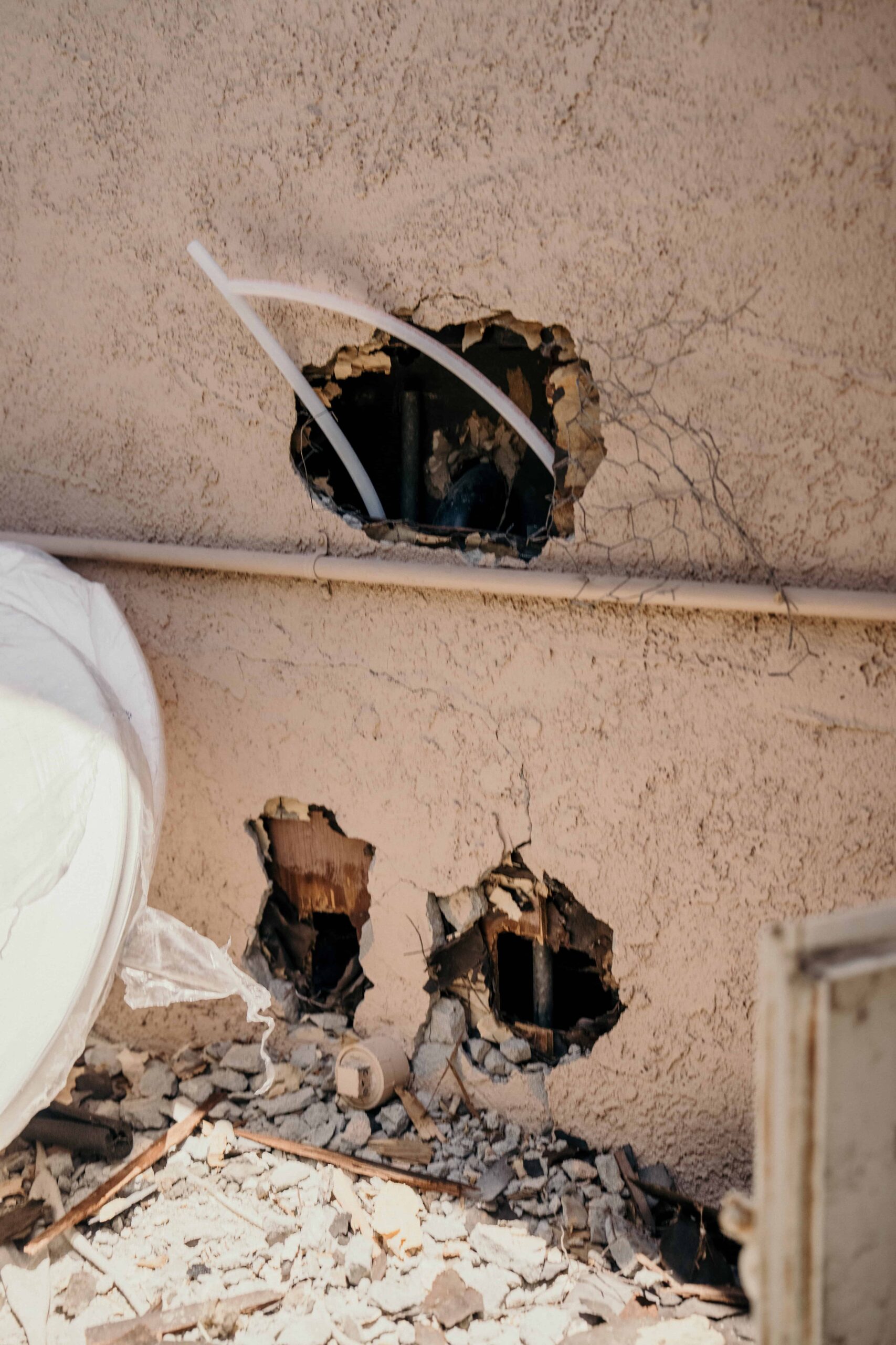 Holes placed in the exterior wall of a house for repiping