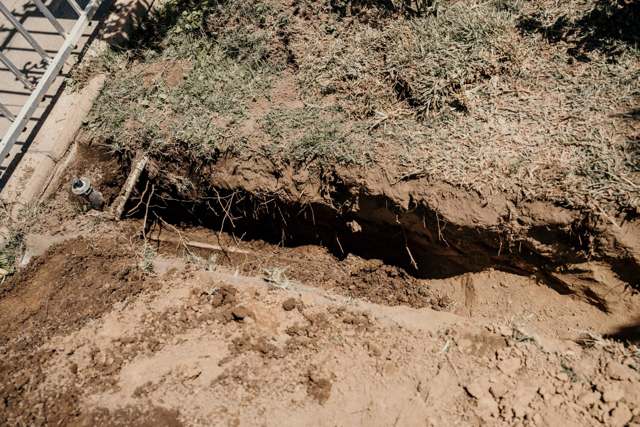 Long ditch dug for a repiping project in a home backyard