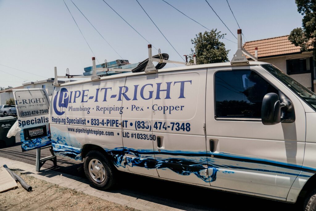 Pipe It Right van parked on the street, outside a job site