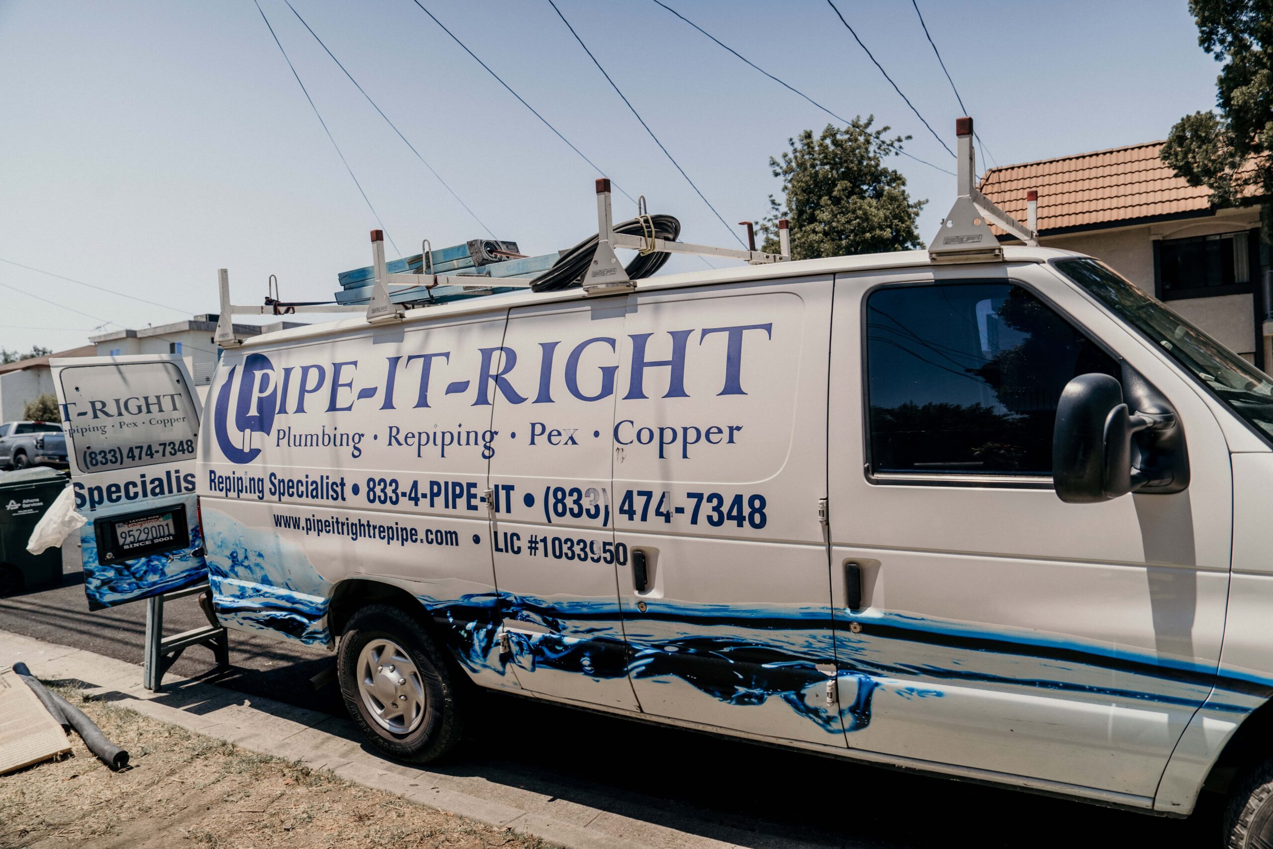 Pipe It Right van parked on the street, outside a job site