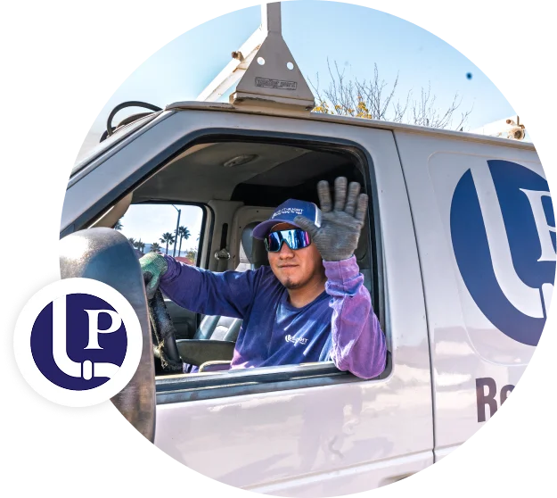 Pipe It Right plumbing technician waving from a branded service vehicle