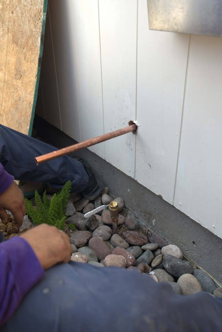 Copper pipe being connected to an outdoor hose spout