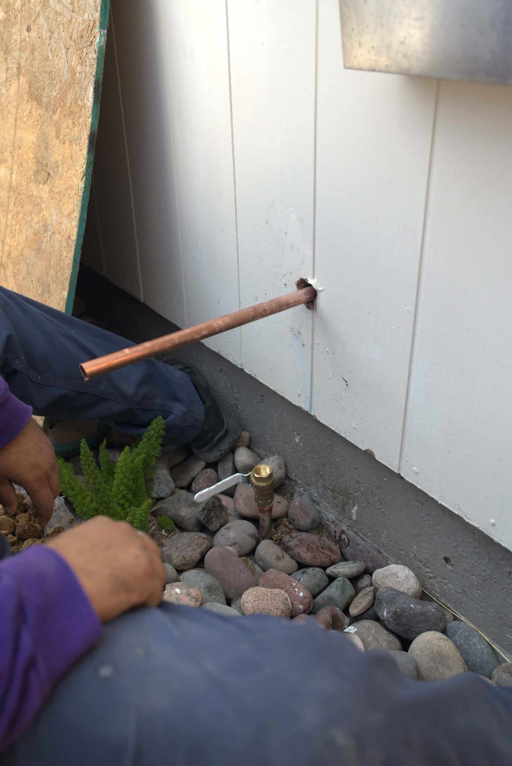 Copper pipe being connected to an outdoor hose spout