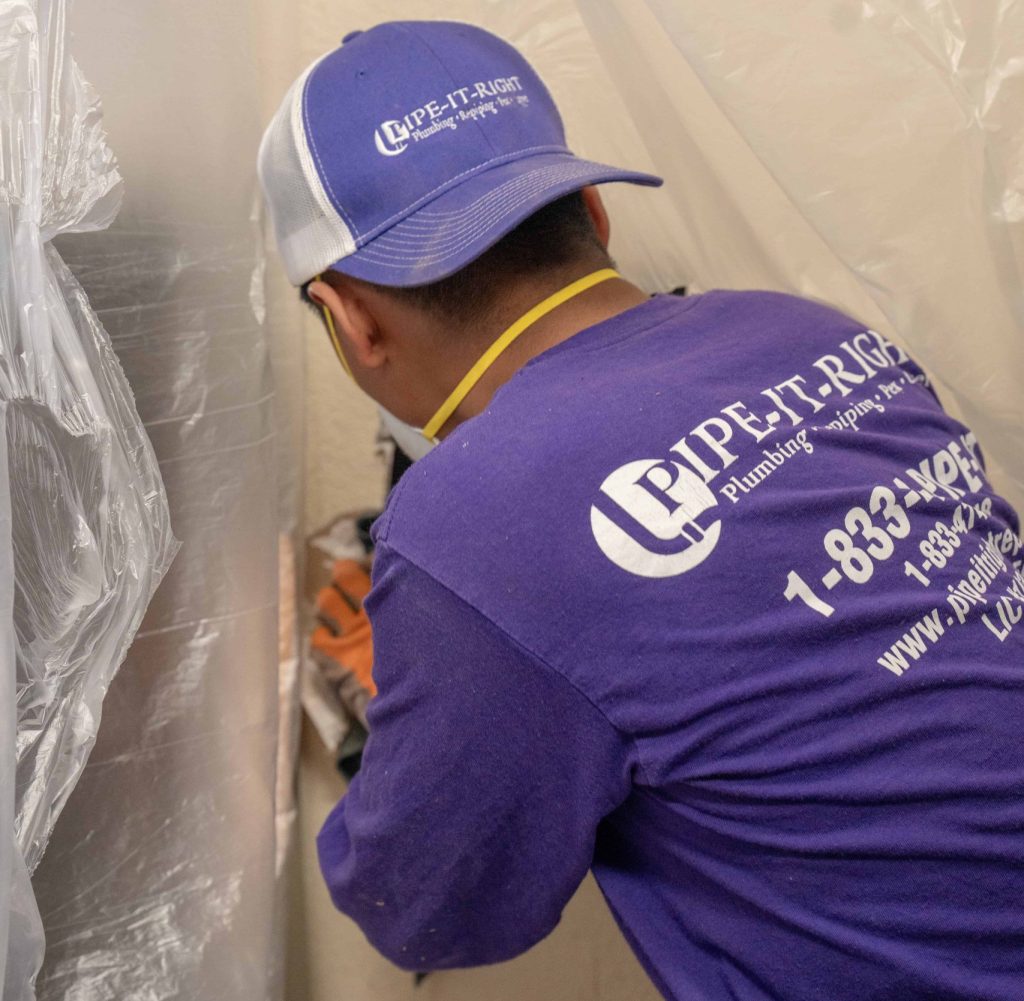 Plumber preparing a wall for repiping